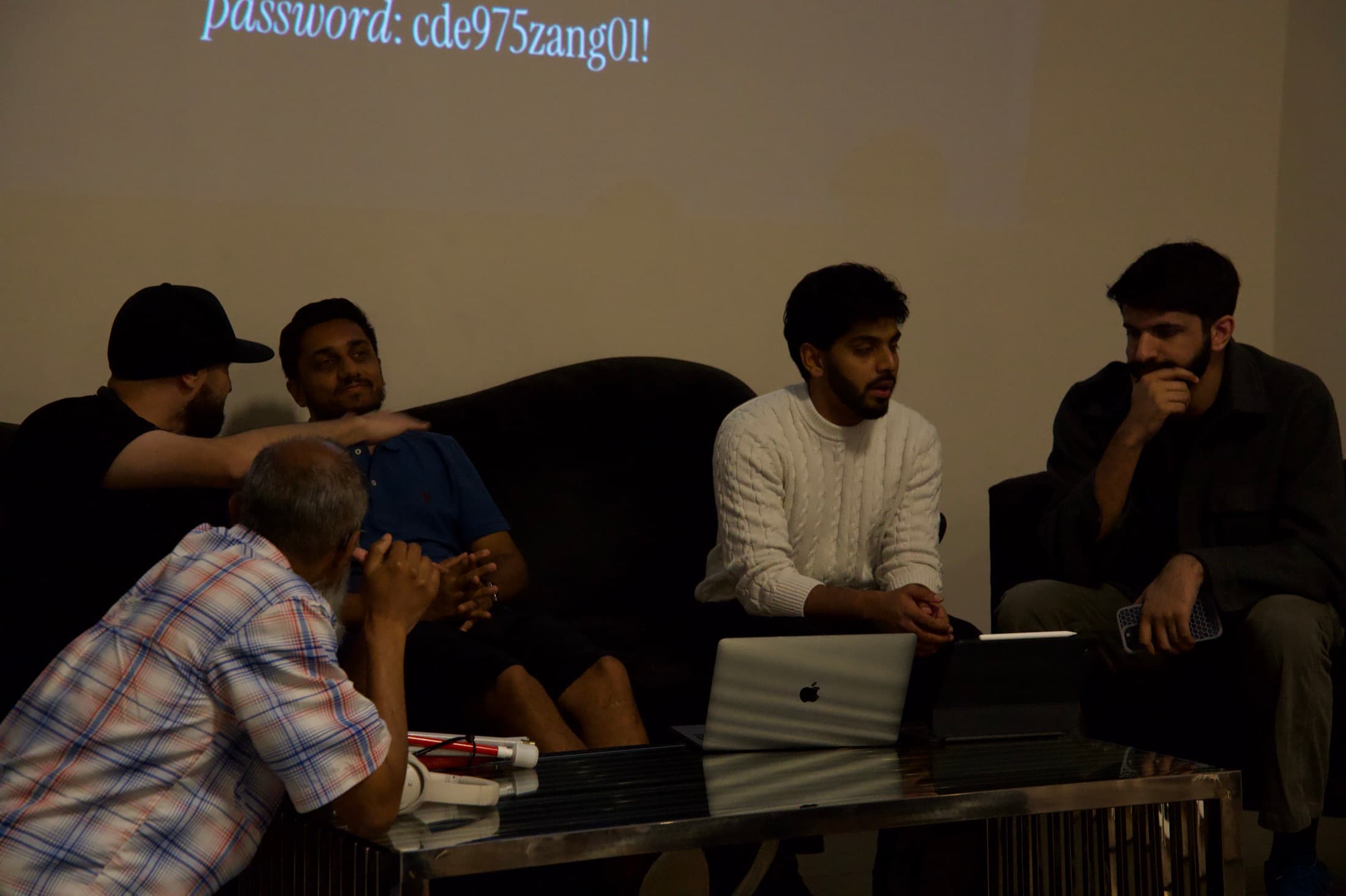A huddle on the couch, gathered around one screen