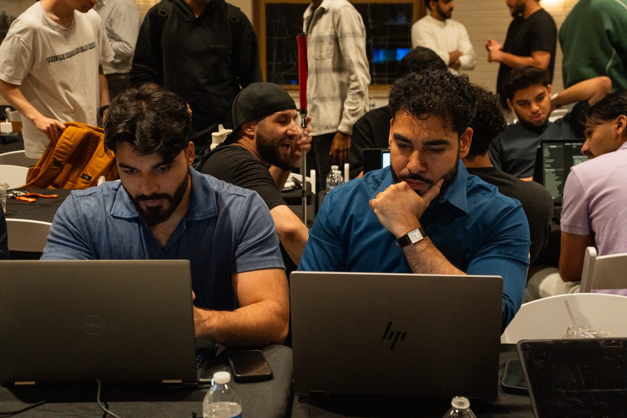 Two builders heads-down at their laptops