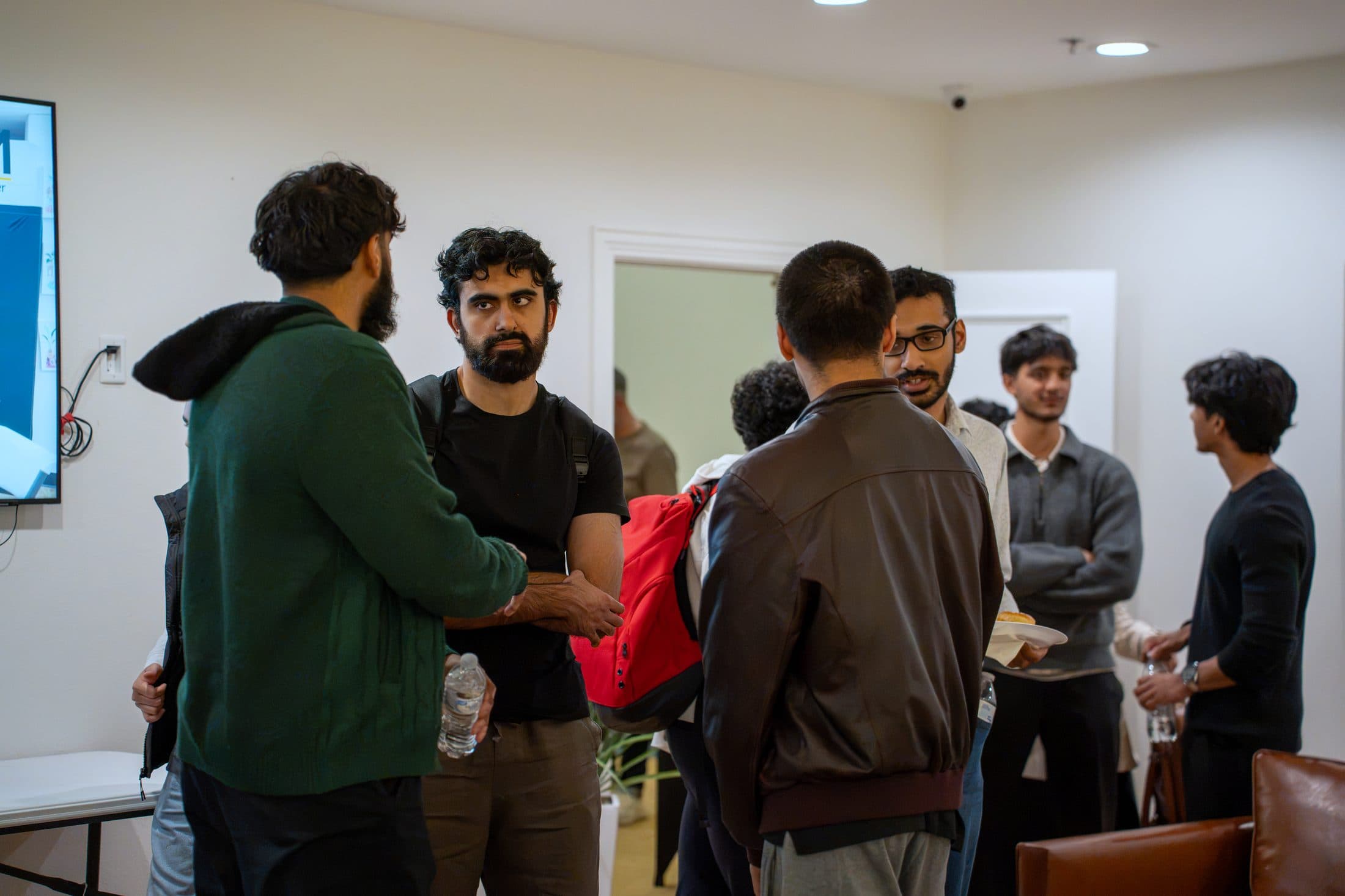 A circle of builders talking by the door
