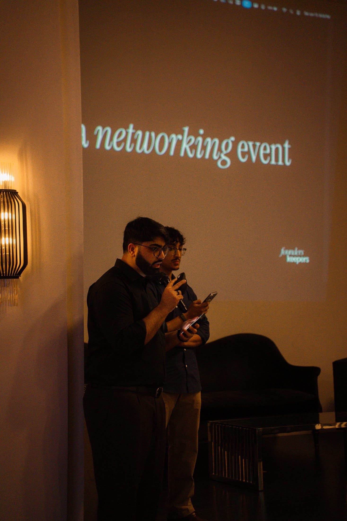 Two speakers in front of the opening slides